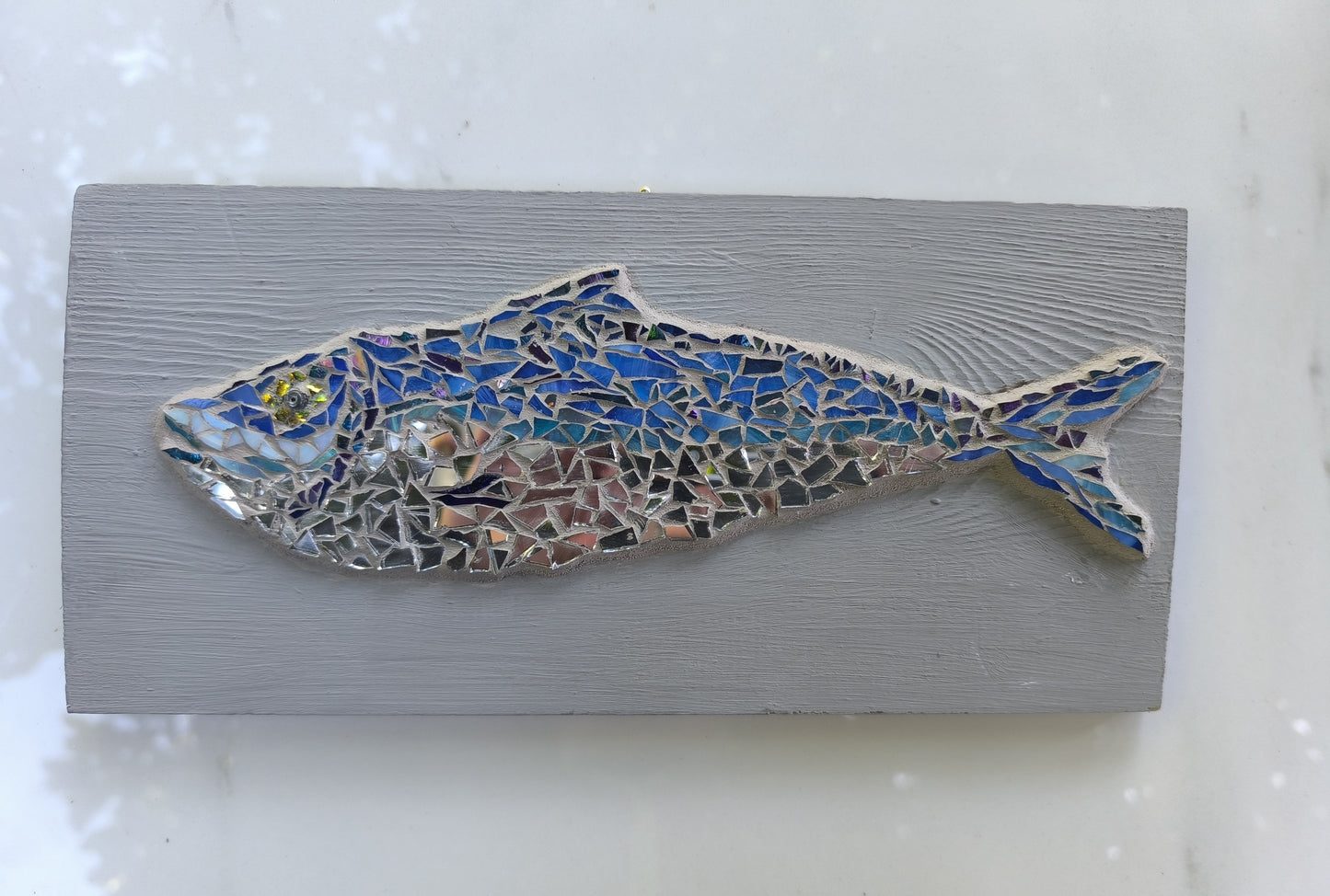 BLUE FISH IN GREY WATERS